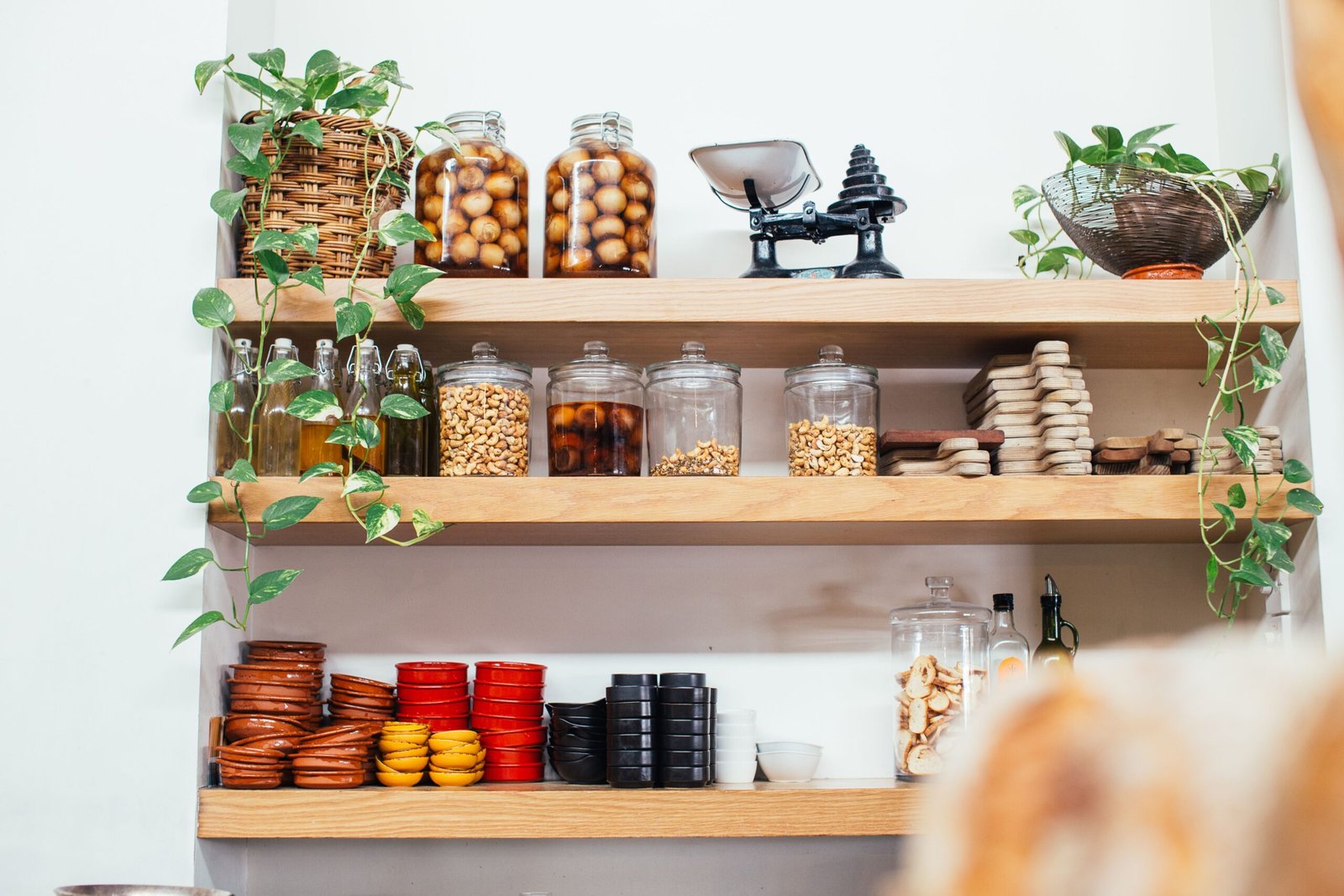 Small kitchen organization with clear containers and shelf risers