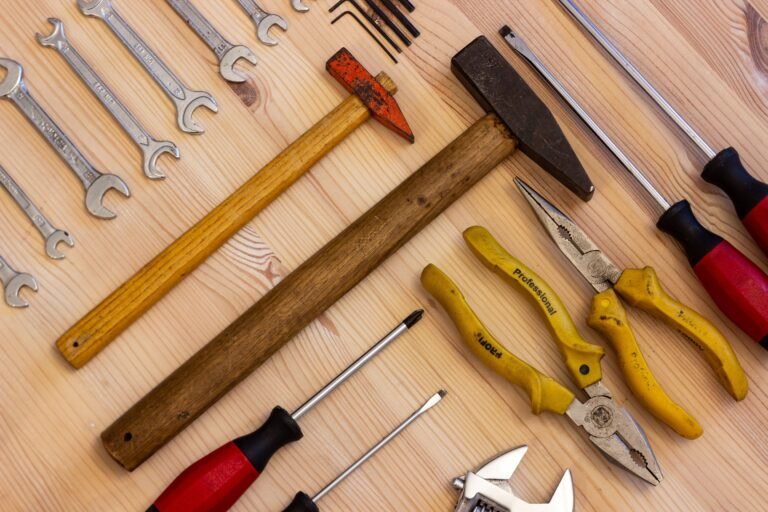 Tools every homeowner needs laid out on a workbench